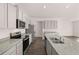 Bright kitchen features stainless steel appliances, a large island, and sleek gray cabinets at 1406 Gray Branch Dr, Lawrenceville, GA 30045