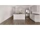 Kitchen with stainless steel appliances, an island, and white cabinets opens to living space at 1406 Gray Branch Dr, Lawrenceville, GA 30045