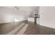 Open-concept living space featuring wood-look floors, ceiling fan, and kitchen with grey cabinets at 1406 Gray Branch Dr, Lawrenceville, GA 30045