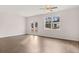 Bright living room with wood-look floors, double doors, and a large window at 1406 Gray Branch Dr, Lawrenceville, GA 30045