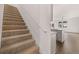 Carpeted staircase leading to an upper floor with an open view to the kitchen area at 1406 Gray Branch Dr, Lawrenceville, GA 30045