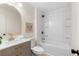 Bathroom features a modern vanity, stylish mirror, and tiled bathtub with shower at 160 Pine Grove Dr, Canton, GA 30114
