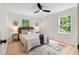 Cozy bedroom with neutral decor, ample natural light, and a ceiling fan at 160 Pine Grove Dr, Canton, GA 30114