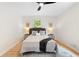 Comfortable bedroom with hardwood floors, neutral color scheme, and ceiling fan at 160 Pine Grove Dr, Canton, GA 30114