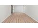 A bright, spacious bedroom with wood-look flooring and a freshly painted white interior at 160 Pine Grove Dr, Canton, GA 30114