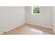 A bright bedroom with wood-look flooring and a large window for natural light and a view at 160 Pine Grove Dr, Canton, GA 30114