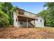 Rear exterior showcasing a wooden deck, brick foundation, and stairs leading to the backyard at 160 Pine Grove Dr, Canton, GA 30114