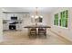 Eat-in kitchen features stainless steel appliances, white cabinets, and a contemporary light fixture at 160 Pine Grove Dr, Canton, GA 30114