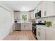 Modern kitchen with stainless steel appliances, white cabinets, and ample countertop space at 160 Pine Grove Dr, Canton, GA 30114