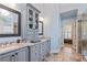 Bathroom featuring dual sinks, granite countertops, a glass-enclosed shower, and ample cabinet space for storage at 3130 Kates Nw Way, Kennesaw, GA 30152