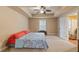 Bedroom with a ceiling fan and neutral carpet, with a glimpse of another room through an open doorway at 3130 Kates Nw Way, Kennesaw, GA 30152