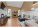 Open-concept living room with fireplace, hardwood floors, and large windows at 3130 Kates Nw Way, Kennesaw, GA 30152