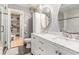 Stylish bathroom with a double vanity, marble countertops, decorative mirrors, and a walk-in closet at 114 Emily Ln, Alpharetta, GA 30009
