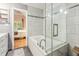Modern bathroom features a soaking tub with glass surround and views of the bedroom at 114 Emily Ln, Alpharetta, GA 30009