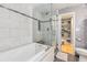 Bright, tiled bathroom features a soaking tub with glass surround and a walk-in closet at 114 Emily Ln, Alpharetta, GA 30009