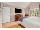 Bright bedroom with large window, neutral walls, and hardwood floors at 114 Emily Ln, Alpharetta, GA 30009