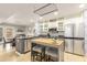 Modern kitchen with stainless steel appliances, an island with seating, and white cabinets at 114 Emily Ln, Alpharetta, GA 30009