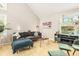 Bright living room featuring vaulted ceiling, plants, and cozy seating arrangement at 114 Emily Ln, Alpharetta, GA 30009