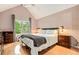 Serene bedroom with vaulted ceilings, large window, and hardwood floors at 114 Emily Ln, Alpharetta, GA 30009