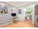 Modern home office with vibrant wallpaper, built-in storage, and natural light at 114 Emily Ln, Alpharetta, GA 30009
