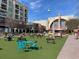 Outdoor seating area with colorful chairs and string lights near shops and a movie theater at 114 Emily Ln, Alpharetta, GA 30009