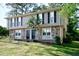 Traditional two-story home with stone accents, black shutters, and a well-maintained lawn at 1142 Forest Villa Nw Dr, Conyers, GA 30012