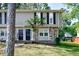 Charming two-story home featuring stone accents, dark shutters, and a neatly kept front yard at 1142 Forest Villa Nw Dr, Conyers, GA 30012