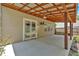 Covered back patio with a ceiling fan, and view of the landscaped backyard at 207 Diamond Valley Pass, Canton, GA 30114