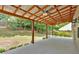 Covered back patio with exposed beams, a concrete floor, and view of the backyard at 207 Diamond Valley Pass, Canton, GA 30114
