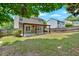 Backyard with a covered patio, grassy lawn, and a surrounding wood fence at 207 Diamond Valley Pass, Canton, GA 30114