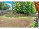 The backyard with a wooden fence, green grass, and a treed border at 207 Diamond Valley Pass, Canton, GA 30114