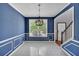 Elegant dining room featuring blue walls, white trim, tile flooring, and a large window for natural light at 207 Diamond Valley Pass, Canton, GA 30114