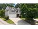 Charming two-story home featuring a light gray siding, attached garage, and well-manicured lawn at 207 Diamond Valley Pass, Canton, GA 30114