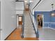 Inviting foyer featuring hardwood floors, a staircase, and views of the dining and kitchen areas at 207 Diamond Valley Pass, Canton, GA 30114