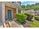 Inviting front entrance with a blue door, brick accents, and manicured bushes with curb appeal at 207 Diamond Valley Pass, Canton, GA 30114