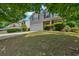 Two-story home with a well-maintained lawn, inviting blue door, and attached garage at 207 Diamond Valley Pass, Canton, GA 30114
