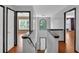 Bright hallway with hardwood floors and staircase leads to upper level with bedrooms and arched window at 207 Diamond Valley Pass, Canton, GA 30114