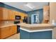 Charming kitchen with stainless steel appliances, tiled backsplash, and adjacent breakfast bar at 207 Diamond Valley Pass, Canton, GA 30114