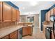 Well-lit kitchen with stainless steel appliances, tiled backsplash, and blue accent wall at 207 Diamond Valley Pass, Canton, GA 30114