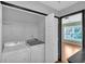 Convenient laundry room with modern washer and dryer, utility sink, and storage shelves at 207 Diamond Valley Pass, Canton, GA 30114