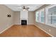 Cozy living room with wood floors, a decorative fireplace, and abundant natural light from large windows at 207 Diamond Valley Pass, Canton, GA 30114