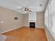 Cozy living room with wood floors, a decorative fireplace, and abundant natural light from large windows at 207 Diamond Valley Pass, Canton, GA 30114