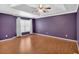 Main bedroom boasts tray ceiling, ceiling fan, and hardwood floors creating an elegant and inviting space at 207 Diamond Valley Pass, Canton, GA 30114