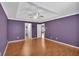 Spacious main bedroom with hardwood floors, tray ceiling, fan, and ensuite bath at 207 Diamond Valley Pass, Canton, GA 30114