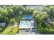 Aerial view of community pool and tennis court with ample parking surrounded by lush trees and well maintained landscaping at 3025 Mountain Creek Ne Ct, Roswell, GA 30075
