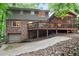 Back exterior view showing the brick and siding, backyard wooden deck, screened in porch and basement garage at 3025 Mountain Creek Ne Ct, Roswell, GA 30075
