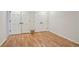 Spacious basement featuring hardwood floors, with white doors and trim at 3025 Mountain Creek Ne Ct, Roswell, GA 30075