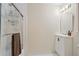 Bright bathroom featuring a glass enclosed shower with caddy and a white vanity with a modern faucet and mirror at 3025 Mountain Creek Ne Ct, Roswell, GA 30075