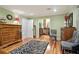 Large bedroom featuring hardwood floors, a zebra rug, and furnishings, conveniently next to an ensuite bathroom at 3025 Mountain Creek Ne Ct, Roswell, GA 30075