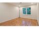 Bedroom features hardwood floors, neutral walls, and a window providing ample natural light at 3025 Mountain Creek Ne Ct, Roswell, GA 30075
